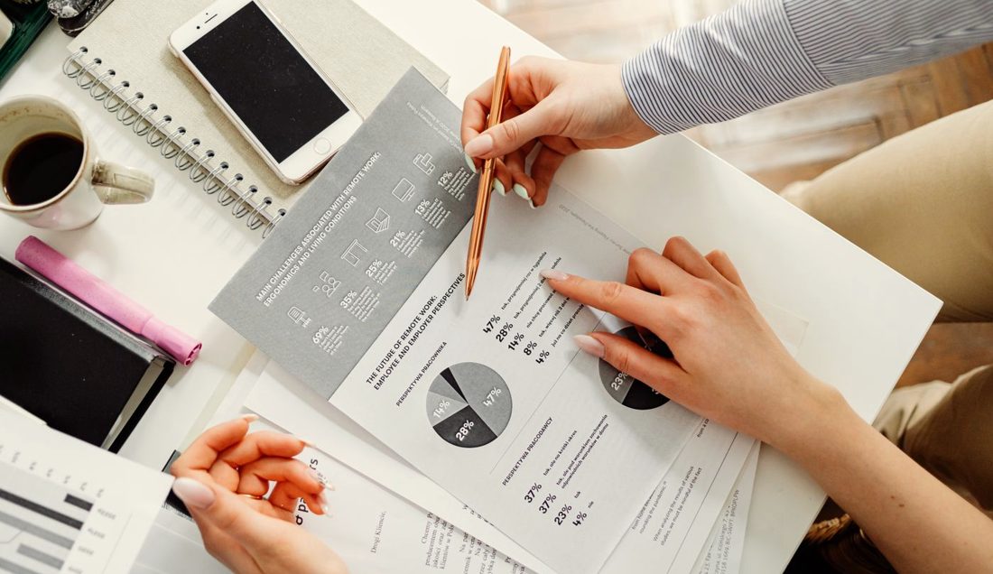 Hands working through a stack of printed contracts and financial documents, the kind of review CaseCraft AI accelerates.