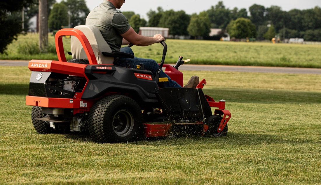 A technician operating a zero-turn mower on turf, the kind of complex equipment FieldCraft AI helps diagnose and service.