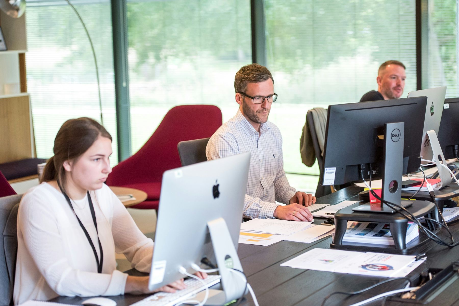 A team working together at their desks, the kind of team an MCPrecision engagement is built around.